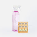 A clear pink spray bottle labeled Blueland Bathroom stands next to six individually packaged cleaning tablets labeled Blueland Bathroom Cleaner Tablet and Eucalyptus Mint.