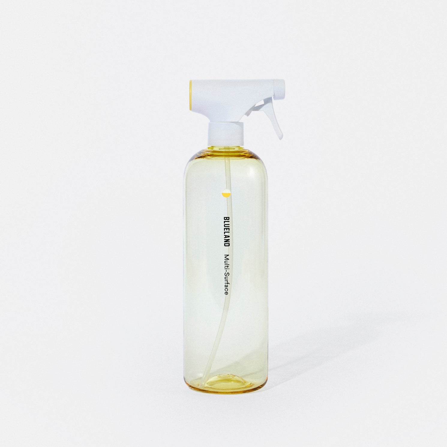 A clear, yellow-tinted spray bottle with a white and yellow nozzle, labeled “BUGLAND Multi Surface” in black text, standing upright against a plain white background.